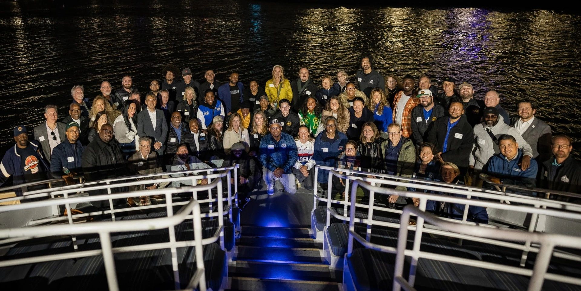 Large group gathered on a boat at a community event